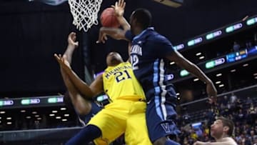 Nov 25, 2014; Brooklyn, NY, USA; Villanova Wildcats forward JayVaughn Pinkston (22) keeps Michigan Wolverines guard/forward Zak Irvin (21) from the basket during the second half at Barclays Center. Villanova Wildcats won 60-55. Mandatory Credit: Anthony Gruppuso-USA TODAY Sports