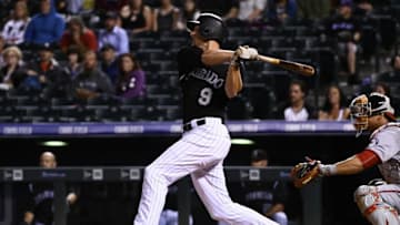 Aug 16, 2016; Denver, CO, USA; Colorado Rockies second baseman DJ LeMahieu (9) triples in the fifth inning at Coors Field. The Rockies defeated the Nationals 6-2. Mandatory Credit: Ron Chenoy-USA TODAY Sports