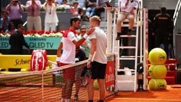 MADRID, SPAIN - MAY 09: Novak Djokovic (l) of Serbia shakes hands with Kyle Edmund of Great Britain after their second round match during day five of the Mutua Madrid Open at La Caja Magica on May 9, 2018 in Madrid, Spain. (Photo by Clive Brunskill/Getty Images)