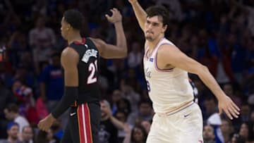 PHILADELPHIA, PA - APRIL 14: Dario Saric #9 of the Philadelphia 76ers reacts in front of Hassan Whiteside #21 of the Miami Heat after making a three point basket in the third quarter during Game One of the first round of the 2018 NBA Playoff at Wells Fargo Center on April 14, 2018 in Philadelphia, Pennsylvania. The 76ers defeated the Heat 130-103. NOTE TO USER: User expressly acknowledges and agrees that, by downloading and or using this photograph, User is consenting to the terms and conditions of the Getty Images License Agreement. (Photo by Mitchell Leff/Getty Images)