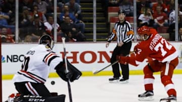 Mar 2, 2016; Detroit, MI, USA; Chicago Blackhawks goalie Corey Crawford (50) makes the save on Detroit Red Wings center Andreas Athanasiou (72) in the third period at Joe Louis Arena. Chicago won 5-2. Mandatory Credit: Rick Osentoski-USA TODAY Sports
