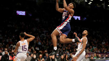Nov 27, 2021; Brooklyn, New York, USA; Brooklyn Nets guard Cam Thomas (24) drives to the basket against Phoenix Suns guard Cameron Payne (15) and forward Mikal Bridges (25) during the fourth quarter at Barclays Center. Mandatory Credit: Brad Penner-USA TODAY Sports