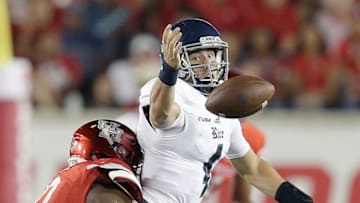 HOUSTON, TX - SEPTEMBER 16: Sam Glaesmann #4 of the Rice Owls fumbles the ball while being tackled by Ed Oliver #10 of the Houston Cougars in the second quarter at TDECU Stadium on September 16, 2017 in Houston, Texas. (Photo by Thomas B. Shea/Getty Images)