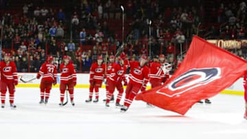Jan 12, 2016; Raleigh, NC, USA; Carolina Hurricanes players celebrate at center ice there win against the Pittsburgh Penguins at PNC Arena. The Carolina Hurricanes defeated the Pittsburgh Penguins 3-2 in overtime. Mandatory Credit: James Guillory-USA TODAY Sports