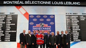 MONTREAL, QC - JUNE 26: Louis Leblanc of Montreal Canadiens poses for a group photo with executives and front office personnel from Candiens after they selected Leblanc #18 overall during the first round of the 2009 NHL Entry Draft at the Bell Centre on June 26, 2009 in Montreal, Quebec, Canada. (Photo by Bruce Bennett/Getty Images)