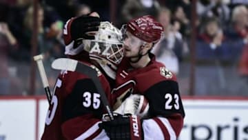 Jan 23, 2016; Glendale, AZ, USA; Arizona Coyotes goalie Louis Domingue (35) and defenseman Oliver Ekman-Larsson (23) celebrate after beating the Los Angeles Kings 3-2 at Gila River Arena. Mandatory Credit: Matt Kartozian-USA TODAY Sports