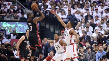 May 3, 2016; Toronto, Ontario, CAN; Miami Heat guard Dwyane Wade (3) takes a shot over Toronto Raptors guards Norman Powell (24) and Kyle Lowry (7) in game one of the second round of the NBA Playoffs at Air Canada Centre. Mandatory Credit: Dan Hamilton-USA TODAY Sports