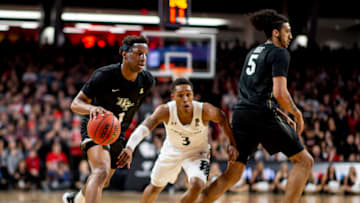 UCF Knights Tony Johnson Jr drives to the basket against Cincinnati Bearcats guard Mika Adams-Woods at Fifth Third Arena. Getty Images.