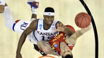 Mar 24, 2016; Louisville, KY, USA; Maryland Terrapins forward Michal Cekovsky (15) and Kansas Jayhawks forward Carlton Bragg Jr. (15) go for a rebound during the first half in a semifinal game in the South regional of the NCAA Tournament at KFC YUM!. Mandatory Credit: Jamie Rhodes-USA TODAY Sports