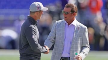 Oct 11, 2015; Baltimore, MD, USA; Baltimore Ravens head coach John Harbaugh (left) and team owner Steve Biscotti (right) meet prior to the game against the Cleveland Browns at M&T Bank Stadium. Mandatory Credit: Mitch Stringer-USA TODAY Sports