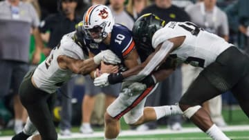 Auburn quarterback Bo Nix (10) fights through defenders for a crucial first down on the final drive of the game at AT&T Stadium in Arlington, Texas, on Saturday, Aug. 31, 2019. Auburn football defeated Oregon 27-21.