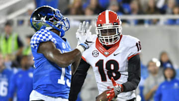 LEXINGTON, KY - NOVEMBER 05: Deandre Baker (18) Georgia Bulldogs defensive back makes an interceptions as a pass slips away from Jeff Badet (13) Kentucky Wildcats wide receiver during the game between the Georgia Bulldogs and Kentucky Wildcats. The Georgia Bulldogs (27) defeated the Kentucky Wildcats (24) on November 05, 2016, at Commonwealth Stadium in Lexington, KY.(Photo by Jeffrey Vest/Icon Sportswire via Getty Images)