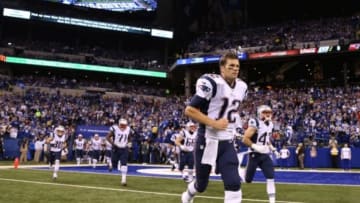 Nov 16, 2014; Indianapolis, IN, USA; New England Patriots quarterback Tom Brady (12) runs onto the field during player introductions before the game against the Indianapolis Colts at Lucas Oil Stadium. Mandatory Credit: Brian Spurlock-USA TODAY Sports