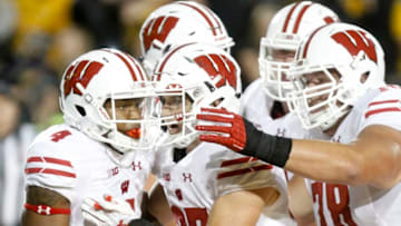 IOWA CITY, IOWA- SEPTEMBER 22: Wide receiver A.J. Taylor #4 celebrates with running back Garrett Groshek #37 of the Wisconsin Badgers after scoring a touchdown in the second half against the Iowa Hawkeyes, on September 22, 2018 at Kinnick Stadium, in Iowa City, Iowa. (Photo by Matthew Holst/Getty Images)