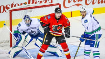 Sep 25, 2015; Calgary, Alberta, CAN; Calgary Flames center Derek Grant (57) and Vancouver Canucks right wing Brandon Prust (9) fight for position in front of Vancouver Canucks goalie Jacob Markstrom (25) during the third period at Scotiabank Saddledome. Calgary Flames won 4-1. Mandatory Credit: Sergei Belski-USA TODAY Sports