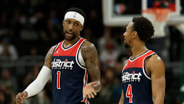MILWAUKEE, WISCONSIN - MARCH 24: Kentavious Caldwell-Pope #1 talks with Ish Smith #4 of the Washington Wizards during the second half of the game against the Milwaukee Bucks at Fiserv Forum on March 24, 2022 in Milwaukee, Wisconsin. NOTE TO USER: User expressly acknowledges and agrees that, by downloading and or using this photograph, User is consenting to the terms and conditions of the Getty Images License Agreement. (Photo by John Fisher/Getty Images)