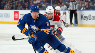 BUFFALO, NY - OCTOBER 14: Robert Hagg #8 of the Buffalo Sabres skates with the puck as Nick Suzuki #14 of the Montreal Canadiens pursues during the third period at KeyBank Center on October 14, 2021 in Buffalo, New York. (Photo by Kevin Hoffman/Getty Images)