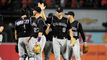 Jul 26, 2016; Baltimore, MD, USA; Colorado Rockies second baseman D.J. LaMahieu (9) high fives teammates after beating the Baltimore Orioles 6-3 at Oriole Park at Camden Yards. Mandatory Credit: Evan Habeeb-USA TODAY Sports