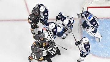 LAS VEGAS, NV - MARCH 21: Ryan Reaves #75 of the Vegas Golden Knights scuffles with Adam Lowry #17 of the Winnipeg Jets during the first period at T-Mobile Arena on March 21, 2019 in Las Vegas, Nevada. (Photo by David Becker/NHLI via Getty Images)