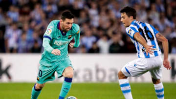 SAN SEBASTIAN, SPAIN - DECEMBER 14: (L-R) Lionel Messi of FC Barcelona, Guevara of Real Sociedad during the La Liga Santander match between Real Sociedad v FC Barcelona at the Estadio Anoeta on December 14, 2019 in San Sebastian Spain (Photo by David S. Bustamante/Soccrates/Getty Images)