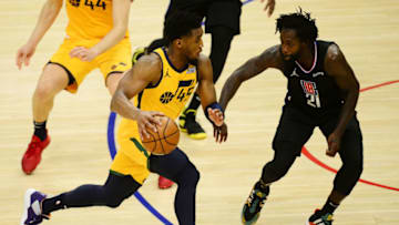 Jun 14, 2021; Los Angeles, California, USA; Utah Jazz guard Donovan Mitchell (45) moves the ball against Los Angeles Clippers guard Patrick Beverley (21) during the second half in game four in the second round of the 2021 NBA Playoffs. at Staples Center. Mandatory Credit: Gary A. Vasquez-USA TODAY Sports