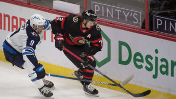 Jan 21, 2021; Ottawa, Ontario, CAN; Winnipeg Jets center Andrew Copp (9) chases Ottawa Senators defenseman Thomas Chabot (72) for control of the puck in the third period at the Canadian Tire Centre. Mandatory Credit: Marc DesRosiers-USA TODAY Sports