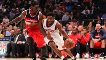 Oct 10, 2016; New York, NY, USA; New York Knicks guard Chasson Randle (4) dribbles the ball past Washington Wizards forward/center Johnny O'Bryant III (7) during the fourth quarter at Madison Square Garden. The Knicks won 90-88. Mandatory Credit: Anthony Gruppuso-USA TODAY Sports