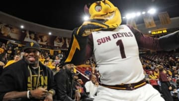 Jan 14, 2016; Tempe, AZ, USA; Arizona State Sun Devils former linebacker Terrell Suggs left poses with Arizona State Sun Devils mascot Sparky looks on during the second half of the game against the Washington State Cougars at Wells-Fargo Arena. The Sun Devils won 84-73. Mandatory Credit: Joe Camporeale-USA TODAY Sports