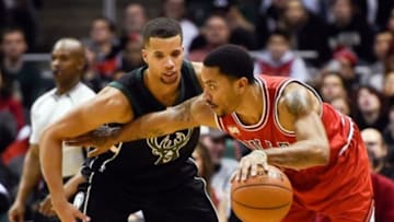 Jan 12, 2016; Milwaukee, WI, USA; Chicago Bulls guard Derrick Rose (1) tries to get around Milwaukee Bucks guard Michael Carter-Williams (5) in the second quarter at BMO Harris Bradley Center. Mandatory Credit: Benny Sieu-USA TODAY Sports