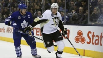 Nov 14, 2014; Toronto, Ontario, CAN; Pittsburgh Penguins forward Beau Bennett (19) carries the puck past Toronto Maple Leafs defenceman Dion Phaneuf (3) at the Air Canada Centre. Pittsburgh defeated Toronto 2-1. Mandatory Credit: John E. Sokolowski-USA TODAY Sports
