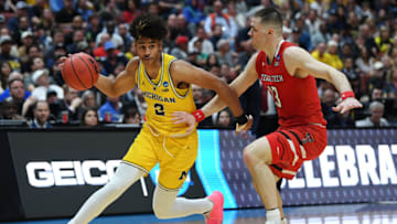 ANAHEIM, CALIFORNIA - MARCH 28: Jordan Poole #2 of the Michigan Wolverines drives against Matt Mooney #13 of the Texas Tech Red Raiders during the 2019 NCAA Men's Basketball Tournament West Regional at Honda Center on March 28, 2019 in Anaheim, California. (Photo by Harry How/Getty Images)