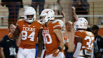 AUSTIN, TX - NOVEMBER 17: Lil'Jordan Humphrey #84 of the Texas Longhorns is congratulated by Cade Brewer #80 and Daniel Young #32 after a third quarter touchdown against the Iowa State Cyclones at Darrell K Royal-Texas Memorial Stadium on November 17, 2018 in Austin, Texas. (Photo by Tim Warner/Getty Images)