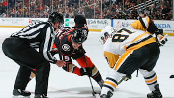ANAHEIM, CA - JANUARY 11: Linesman Jesse Marquis #86 prepares to drop a face-off for Ryan Getzlaf #15 of the Anaheim Ducks and Sidney Crosby #87 of the Pittsburgh Penguins during the first period of the game at Honda Center on January 11, 2019 in Anaheim, California. (Photo by Debora Robinson/NHLI via Getty Images)