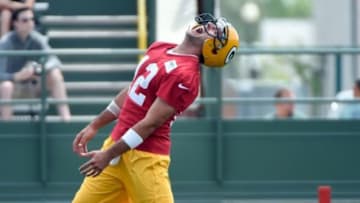 Jun 17, 2014; Green Bay, WI, USA; Green Bay Packers quarterback Aaron Rodgers reacts during the team