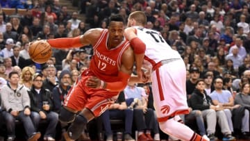 Mar 6, 2016; Toronto, Ontario, CAN; Houston Rockets center Dwight Howard (12) dribbles past Toronto Raptors guard Jonas Valanciunas (17) in the second quarter at Air Canada Centre. Mandatory Credit: Dan Hamilton-USA TODAY Sports