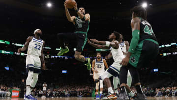 Mar 27, 2022; Boston, Massachusetts, USA; Boston Celtics forward Jayson Tatum (0) goes between Minnesota Timberwolves guard Patrick Beverley (22) and forward Anthony Edwards (1) during the second quarter at TD Garden. Mandatory Credit: Winslow Townson-USA TODAY Sports