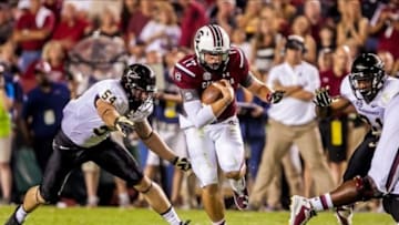 Sep 14, 2013; Columbia, SC, USA; South Carolina Gamecocks quarterback Dylan Thompson (17) scrambles for yardage as Vanderbilt Commodores defensive end Jimmy Stewart (54) pursues in the second quarter at Williams-Brice Stadium. Mandatory Credit: Jeff Blake-USA TODAY Sports