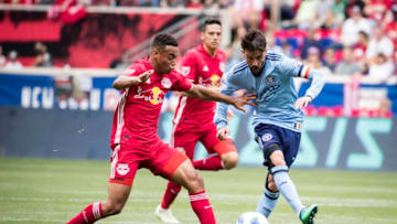 HARRISON, NJ - MAY 5 : David Villa #7 of New York City kicks toward the goal with Tyler Adams #4 of New York Red Bulls attempting to stop him during the New York Derby Major League Soccer match between New York City FC and New York Red Bulls at Red Bull Arena on May 5, 2018 in Harrison, NJ. New York Red Bulls won the match with a score of 4 to 0. (Photo by Ira L. Black/Corbis via Getty Images)