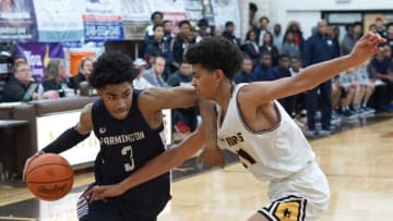Farmington High player, and MSU recruit, Jaden Akins dribbles to the basket as he's guarded by North Farmington's Basheer Jihad.Farmvsnfarmingtonhoops2
