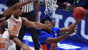 Mar 12, 2021; Nashville, Tennessee, USA; Florida Gators guard Tyree Appleby (22) scores past Tennessee Volunteers guard Yves Pons (35) and guard Victor Bailey Jr. (12) during the first half at Bridgestone Arena. Mandatory Credit: Christopher Hanewinckel-USA TODAY Sports