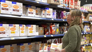 OVERLAND PARK, KS - APRIL 07: A woman wearing a mask shops for Passover items at a grocery store during the coronavirus pandemic on April 07, 2020 in Overland Park, Kansas. The Passover seder is one of the most important annual events in the Jewish faith. Because the coronavirus (COVID-19) has required unprecedented social distancing policies, families are being forced to find ways to celebrate the holiday differently this year or cancel plans altogether. (Photo by Jamie Squire/Getty Images)
