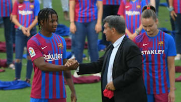 FC Barcelona president Joan Laporta (C) shakes hands with Barcelona's Spanish midfielder Ansu Fati next to Barcelona's Norwegian forward Caroline Graham Hansen during the presentation of the club´s new jerseys in Barcelona on June 15, 2021. - (Photo by LLUIS GENE / AFP) (Photo by LLUIS GENE/AFP via Getty Images)
