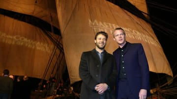 SAN DIEGO - NOVEMBER 9: Actors Russell Crowe (L) and Paul Bettany pose for photos in front of the HMS Rose, which was used in the filming of the movie "Master and Commander: The Far Side Of The World", during the film's San Diego premiere November 9, 2003 in San Diego, California. The film was screened on the Broadway Pier in downtown San Diego. The film goes into wide release November 14, 2003. (Photo by Carlo Allegri/Getty Images)
