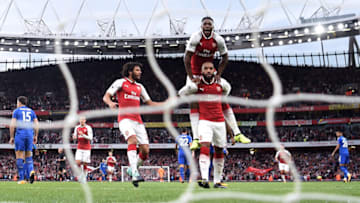 LONDON, ENGLAND - AUGUST 11: Alexandre Lacazette of Arsenal celebrates with teammates Mohamed Elneny (L) and Danny Welbeck (R) after scoring the opening goal during the Premier League match between Arsenal and Leicester City at the Emirates Stadium on August 11, 2017 in London, England. (Photo by Michael Regan/Getty Images)