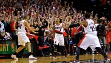 May 2, 2014; Portland, OR, USA; Portland Trail Blazers guard Damian Lillard (0) reacts after hitting the game winning shot against the Houston Rockets during the fourth quarter in game six of the first round of the 2014 NBA Playoffs at the Moda Center. Mandatory Credit: Craig Mitchelldyer-USA TODAY Sports