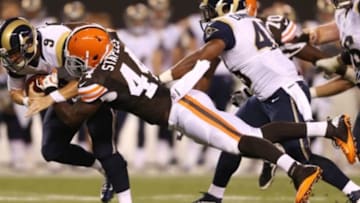 Aug 8, 2013; Cleveland, OH, USA; Cleveland Browns defensive lineman Justin Staples (44) brings down St. Louis Rams quarterback Austin Davis (9) during the fourth quarter at FirstEnergy Field. Mandatory Credit: Ron Schwane-USA TODAY Sports