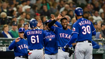 SEATTLE, WA - SEPTEMBER 28: Jurickson Profar #19 of the Texas Rangers, facing, greets Nomar Mazara #30 after he scored on a home run by Robinson Chirinos #61 in the fourth inning against the Seattle Mariners at Safeco Field on September 28, 2018 in Seattle, Washington. (Photo by Lindsey Wasson/Getty Images)