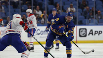 Oct 14, 2021; Buffalo, New York, USA; Buffalo Sabres center Zemgus Girgensons (28) shoots the puck up ice during the second period against the Montreal Canadiens at KeyBank Center. Mandatory Credit: Timothy T. Ludwig-USA TODAY Sports