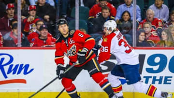 Jan 13, 2016; Calgary, Alberta, CAN; Calgary Flames defenseman Dennis Wideman (6) and Florida Panthers left wing Jussi Jokinen (36) battle for the puck during the first period at Scotiabank Saddledome. Mandatory Credit: Sergei Belski-USA TODAY Sports