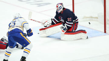 Dec 14, 2021; Winnipeg, Manitoba, CAN; Buffalo Sabres forward Jeff Skinner (53) scores on Winnipeg Jets goalie Connor Hellebuyck (37) during the third period at Canada Life Centre. Mandatory Credit: Terrence Lee-USA TODAY Sports